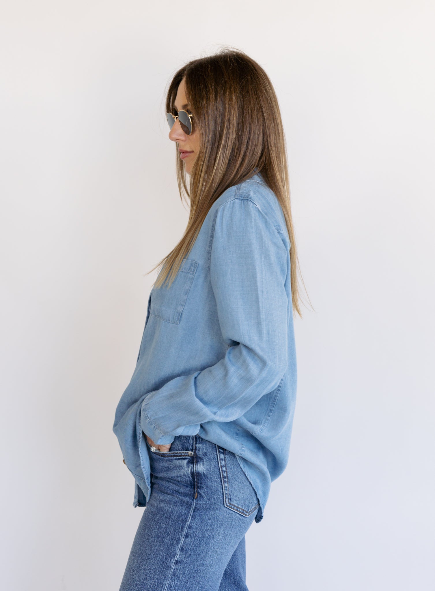 Woman wearing the Ginger Shirt, a light denim wash Tencel button-front chambray shirt