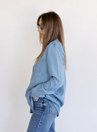 Woman wearing the Ginger Shirt, a light denim wash Tencel button-front chambray shirt