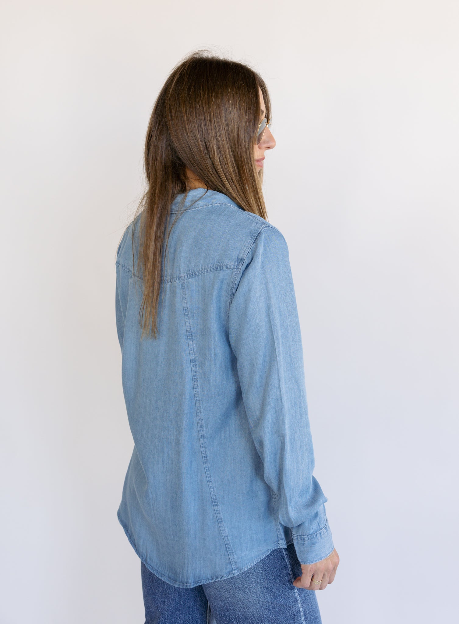 Woman wearing the Ginger Shirt, a light denim wash Tencel button-front chambray shirt