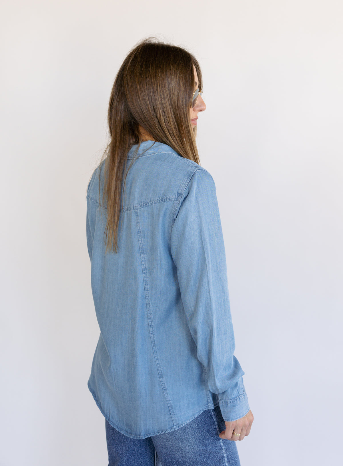 Woman wearing the Ginger Shirt, a light denim wash Tencel button-front chambray shirt