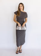 Woman wearing the Project Social T Laurel Dress, an off-the-shoulder brushed rib maxi dress with a waist tie