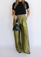 Woman wearing the Sophia Pleated Pants, olive high-rise wide-leg pleated pants