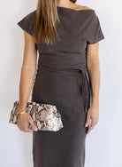 Woman wearing the Project Social T Laurel Dress, an off-the-shoulder brushed rib maxi dress with a waist tie