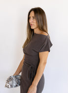 Woman wearing the Project Social T Laurel Dress, an off-the-shoulder brushed rib maxi dress with a waist tie