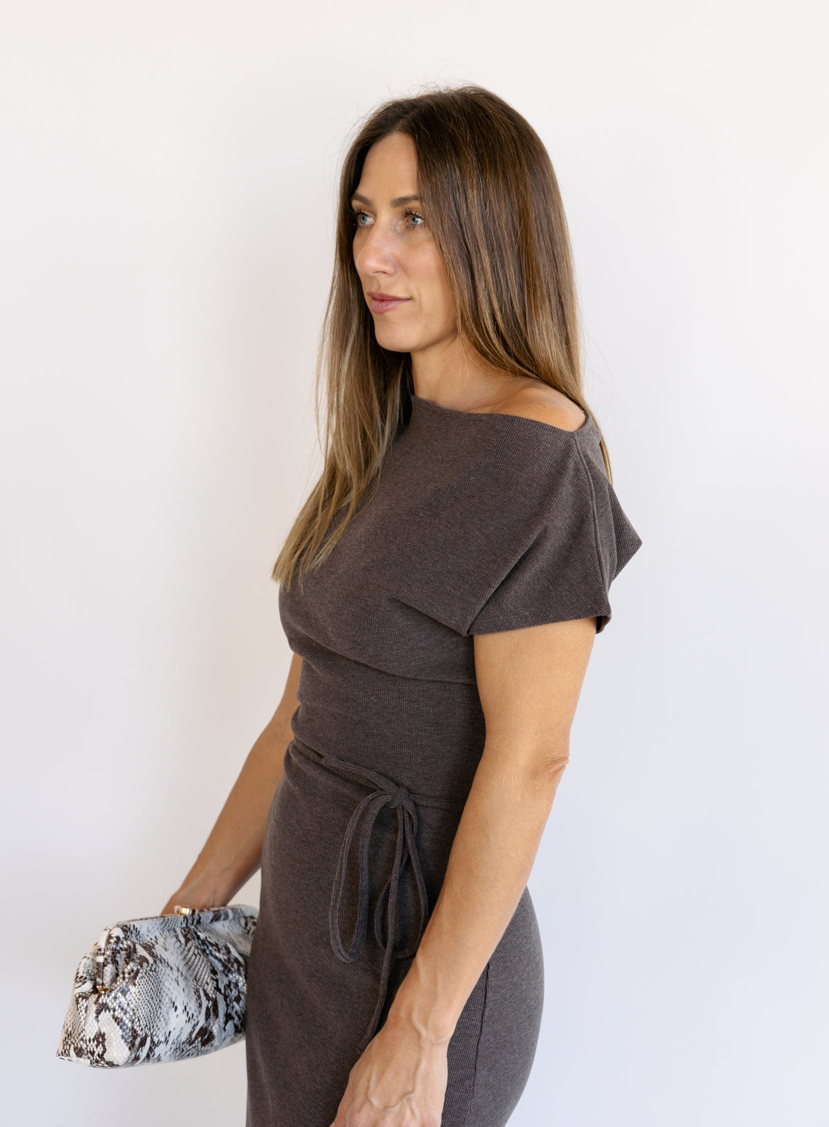 Woman wearing the Project Social T Laurel Dress, an off-the-shoulder brushed rib maxi dress with a waist tie