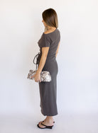 Woman wearing the Project Social T Laurel Dress, an off-the-shoulder brushed rib maxi dress with a waist tie