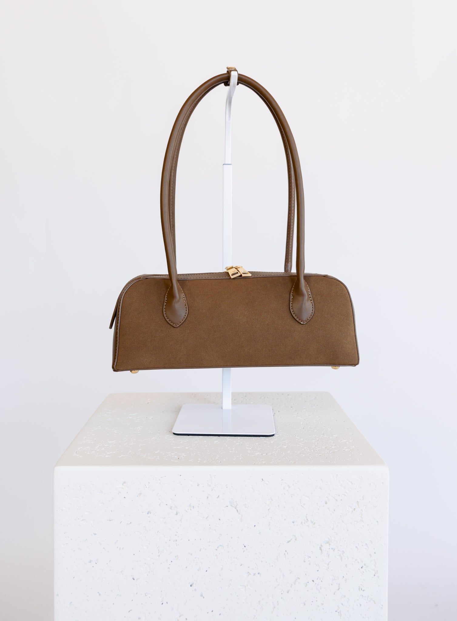 Jonava Suede Bag in Espresso, an elongated suede shoulder bag with gold zipper pulls