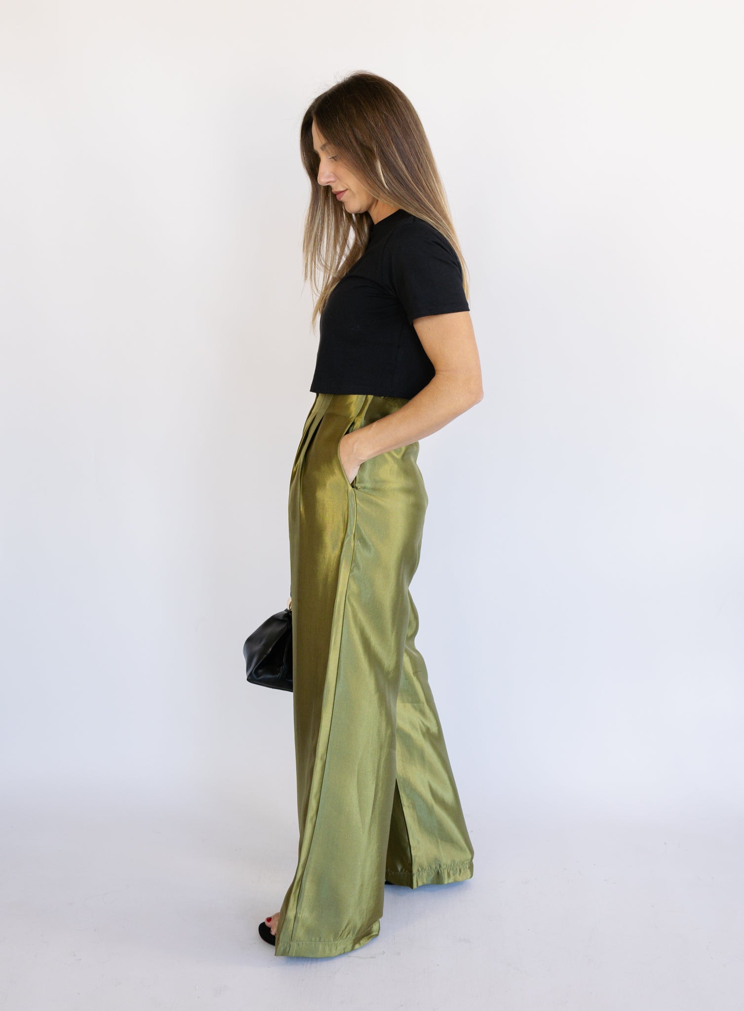 Woman wearing the Sophia Pleated Pants, olive high-rise wide-leg pleated pants
