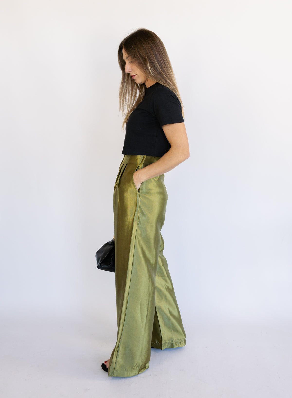 Woman wearing the Sophia Pleated Pants, olive high-rise wide-leg pleated pants