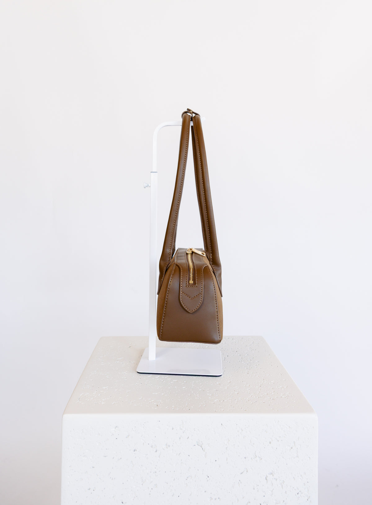 Jonava Suede Bag in Espresso, an elongated suede shoulder bag with gold zipper pulls