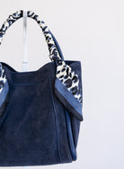 Giselle Suede Bag in Navy, a slouchy suede tote with navy and white leopard scarves on the handles