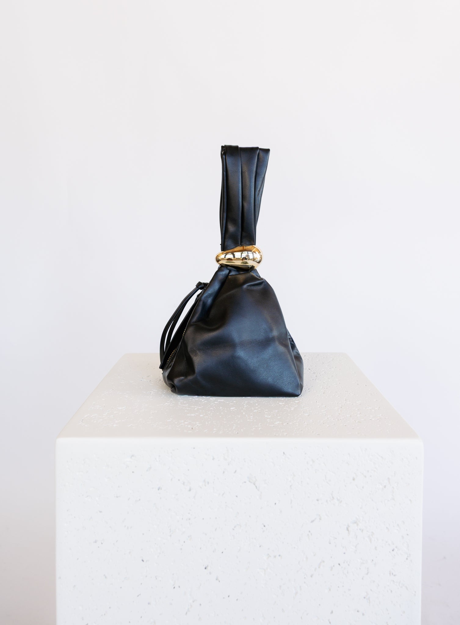 Celine Evening Bag, a slouchy black pouch with a gold cuff handle