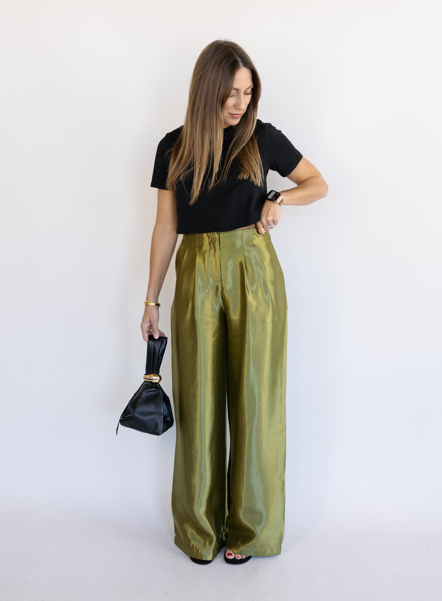 Woman wearing the Sophia Pleated Pants, olive high-rise wide-leg pleated pants