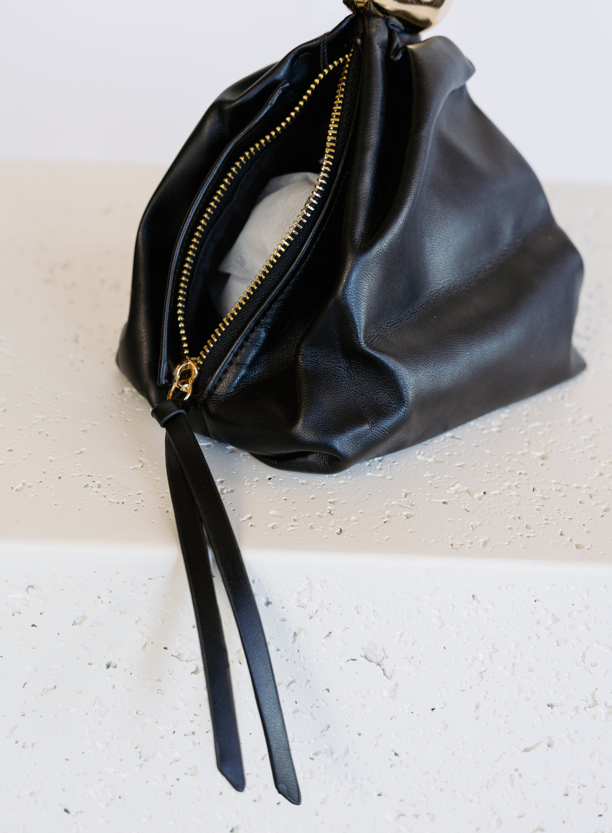 Celine Evening Bag, a slouchy black pouch with a gold cuff handle