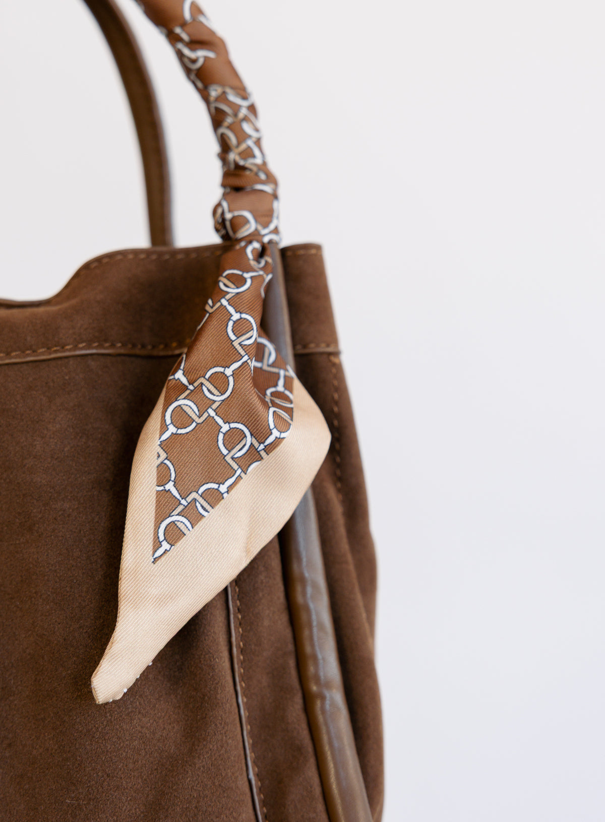 Giselle Suede Bag in Chocolate, a slouchy suede tote with cream chain-print scarves on the handles