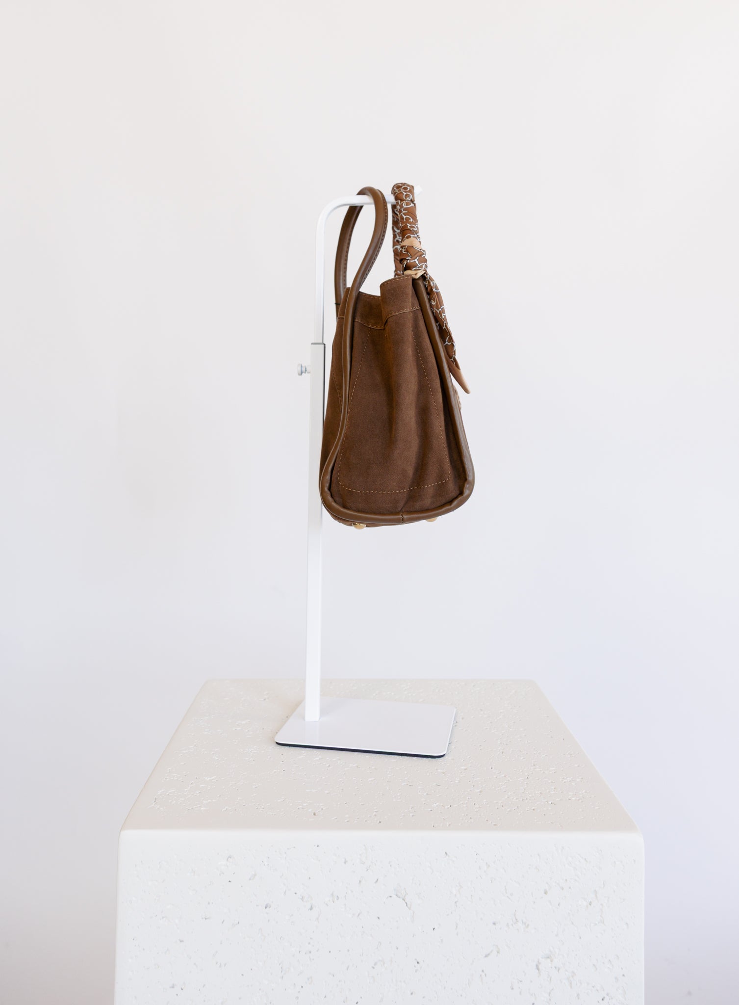 Giselle Suede Bag in Chocolate, a slouchy suede tote with cream chain-print scarves on the handles