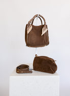 Giselle Suede Bag in Chocolate, a slouchy suede tote with cream chain-print scarves on the handles