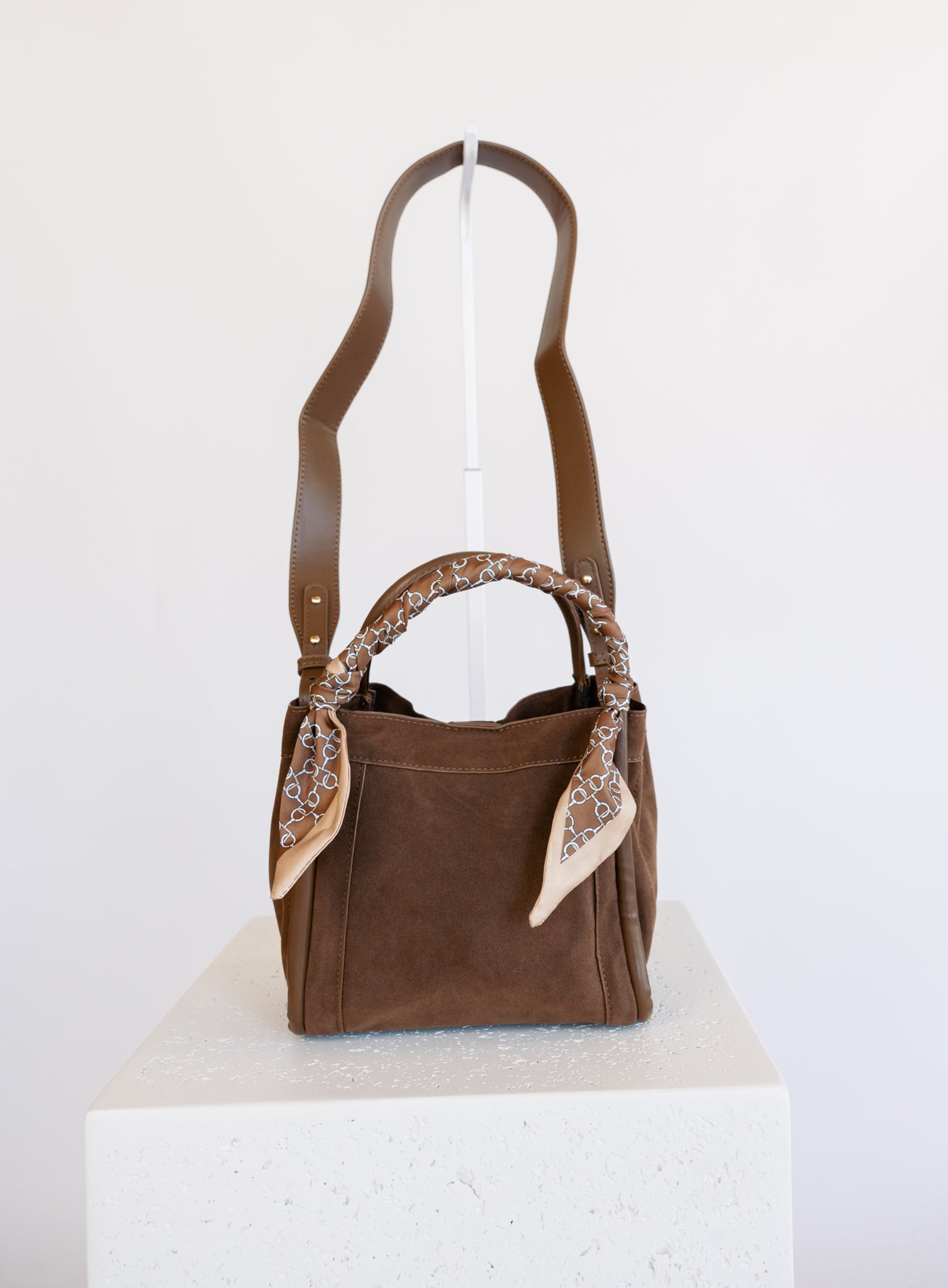 Giselle Suede Bag in Chocolate, a slouchy suede tote with cream chain-print scarves on the handles