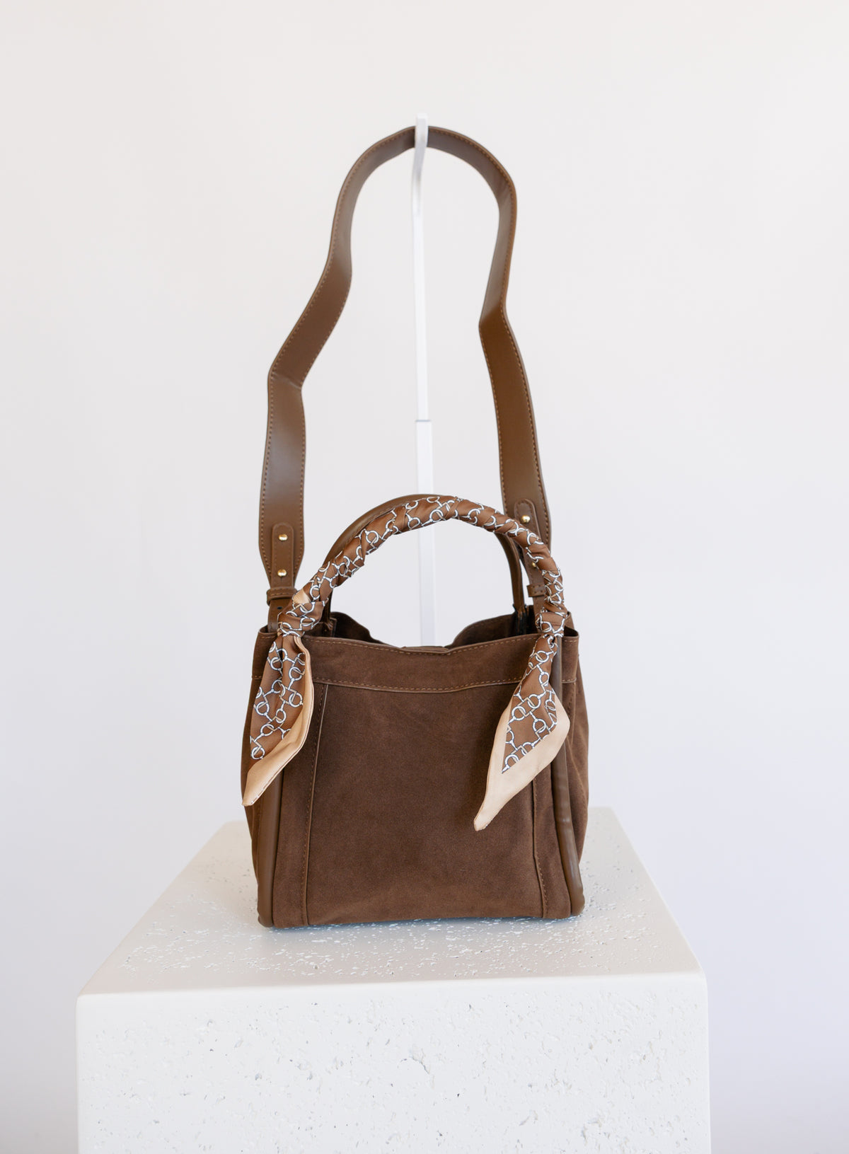Giselle Suede Bag in Chocolate, a slouchy suede tote with cream chain-print scarves on the handles