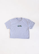 Jags Embroidered Crop Tee, a heather grey crewneck crop tee with a teal and gold embroidered jaguar