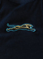 Jags Embroidered Crop Tank, a jet black high-neck crop tank with a teal and gold embroidered jaguar