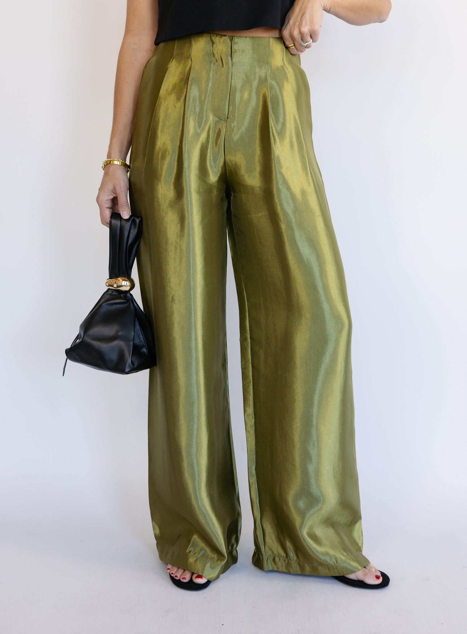 Woman wearing the Sophia Pleated Pants, olive high-rise wide-leg pleated pants