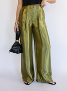 Woman wearing the Sophia Pleated Pants, olive high-rise wide-leg pleated pants