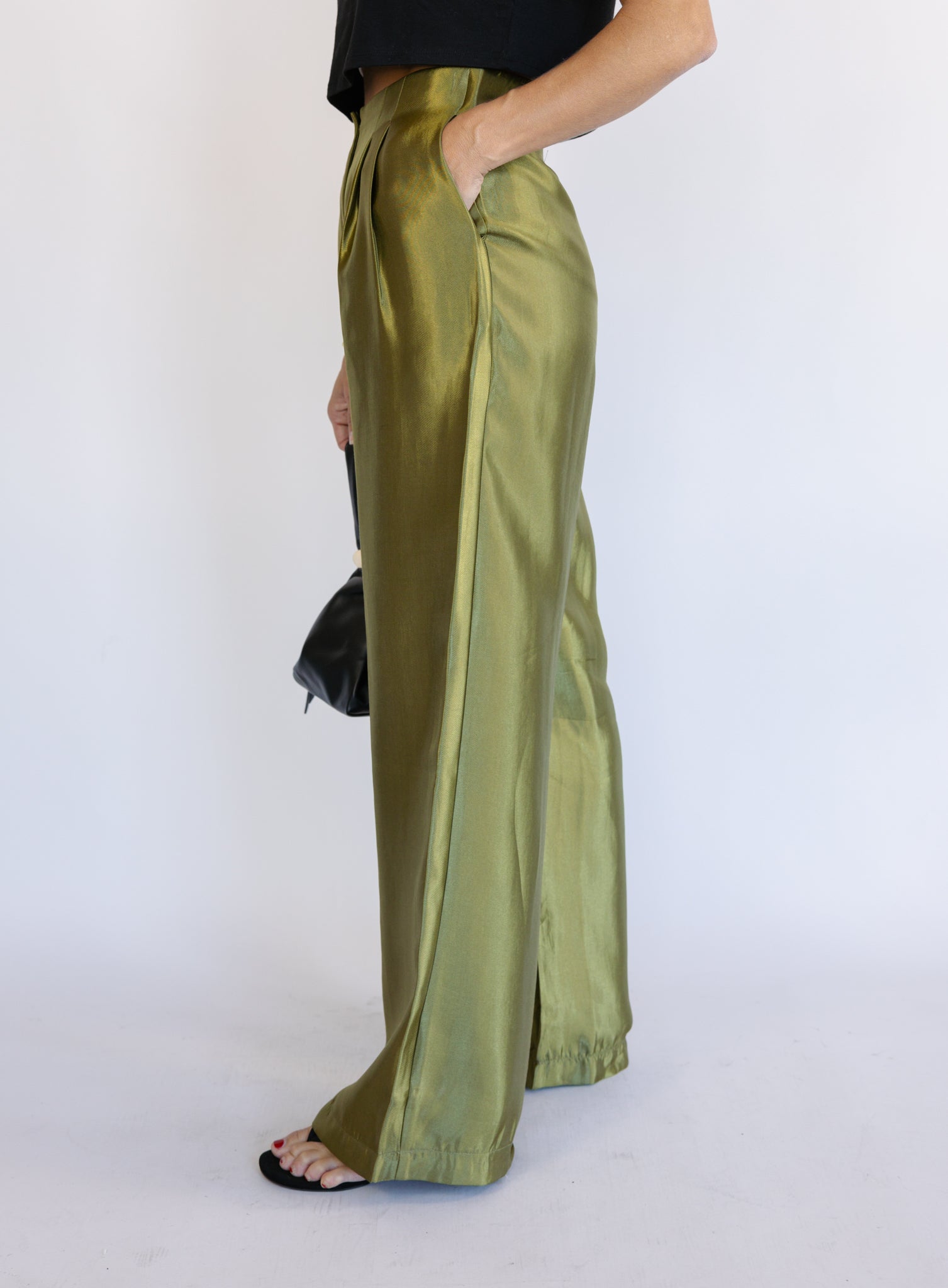 Woman wearing the Sophia Pleated Pants, olive high-rise wide-leg pleated pants