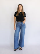 Woman wearing Z Supply The Stunner Mid Rise Wide Leg jeans in Element, a vintage medium wash