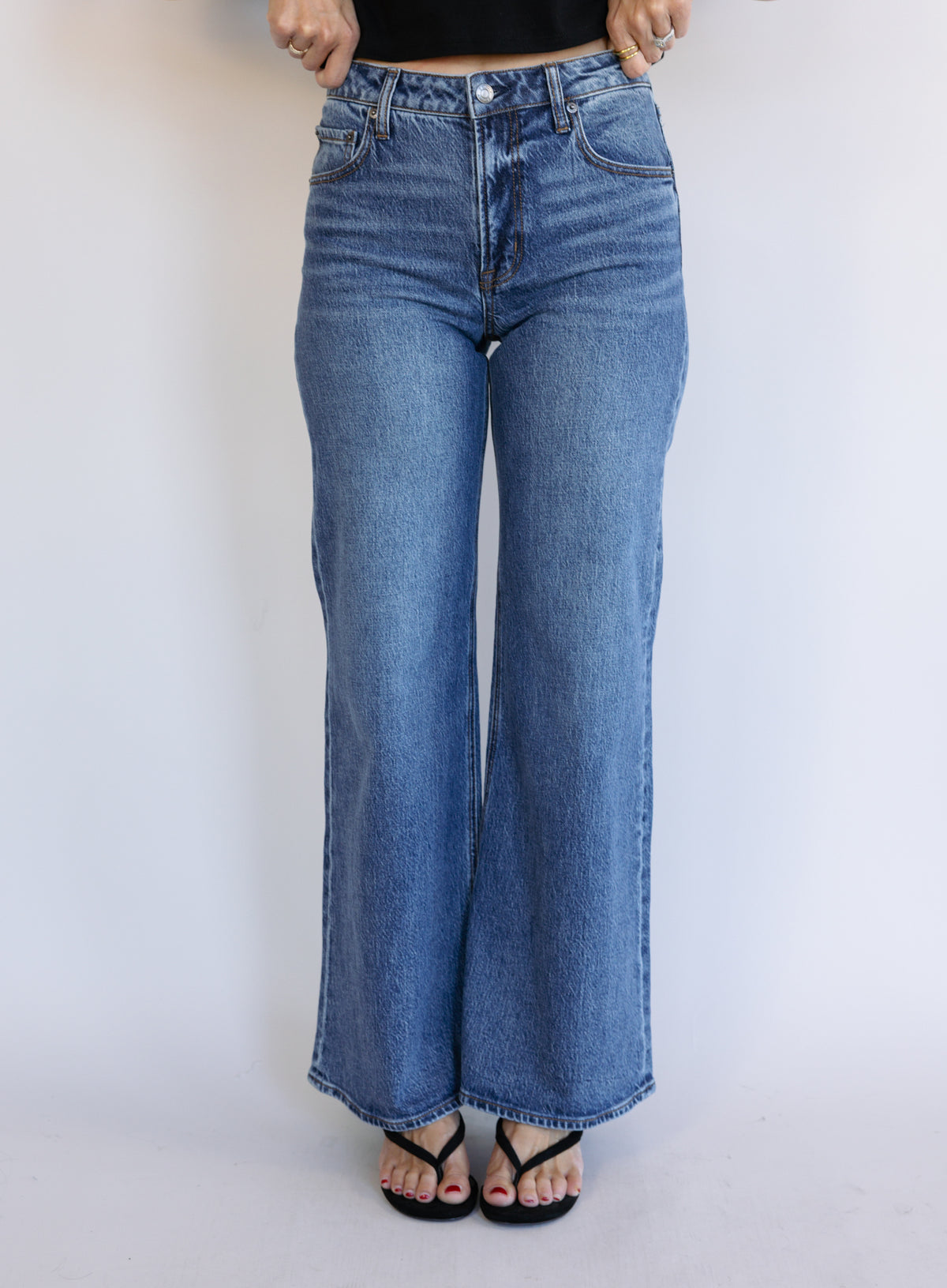 Woman wearing Z Supply The Stunner Mid Rise Wide Leg jeans in Element, a vintage medium wash