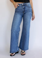 Woman wearing Z Supply The Stunner Mid Rise Wide Leg jeans in Element, a vintage medium wash