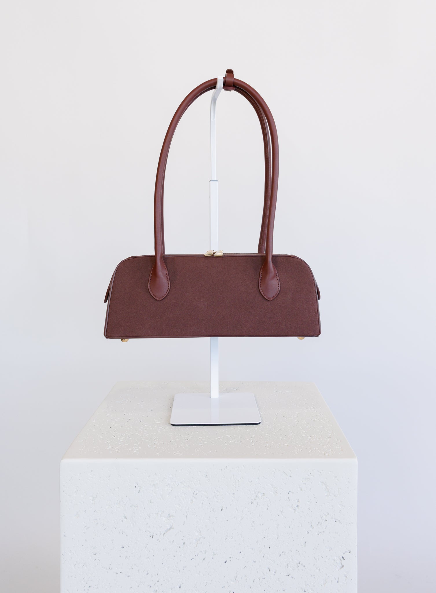 Jonava Suede Bag in Garnet, a deep garnet elongated suede shoulder bag with gold zipper pulls