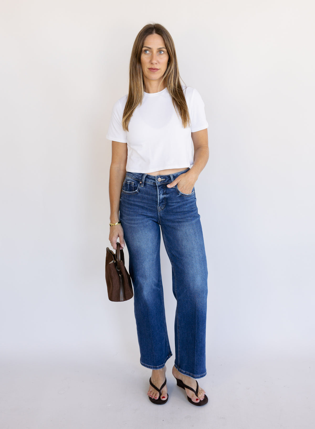 Woman wearing Favorite Daughter The Laura Crop Top in White, a fitted cropped crewneck tee