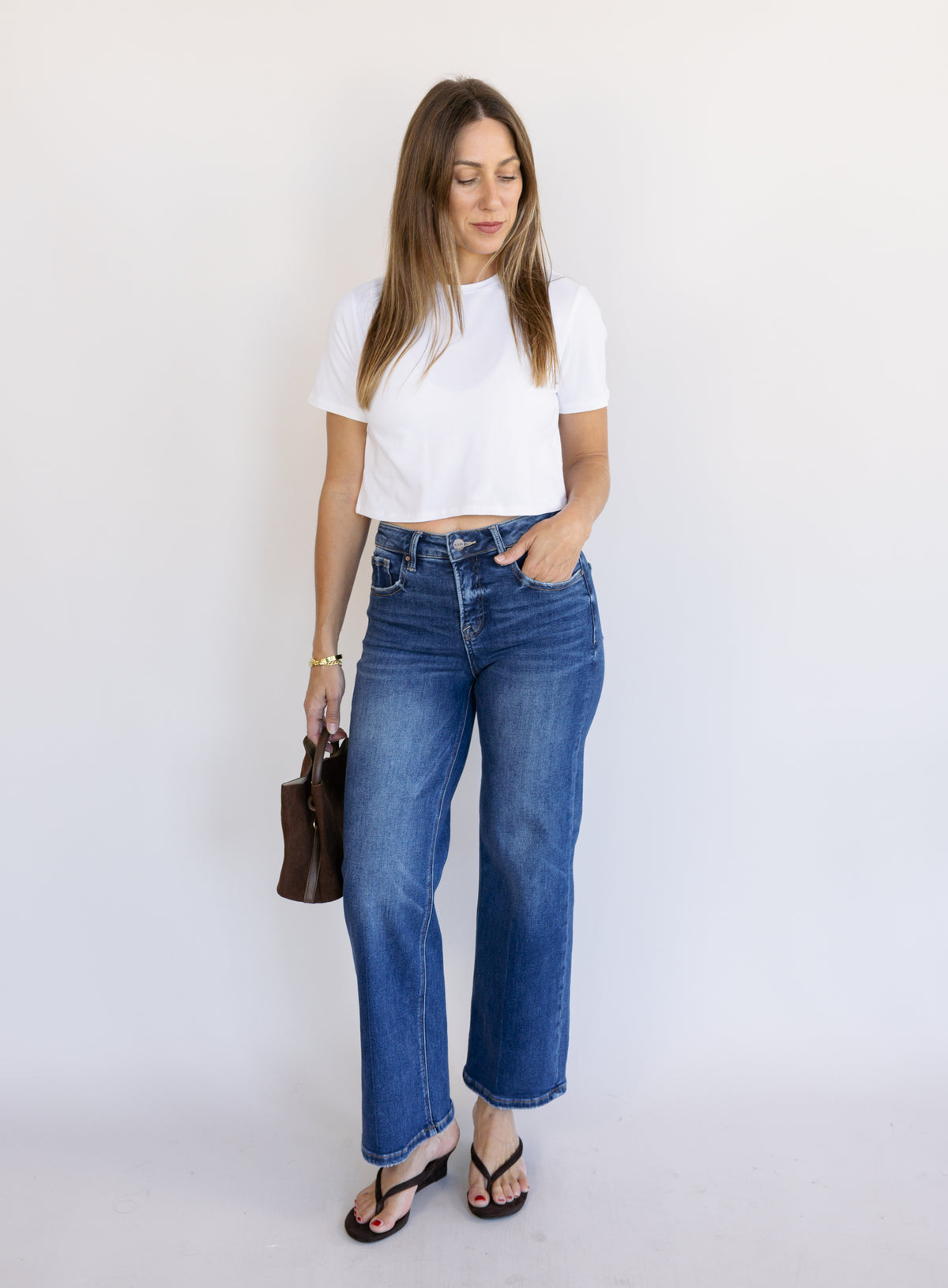 Woman wearing Favorite Daughter The Laura Crop Top in White, a fitted cropped crewneck tee