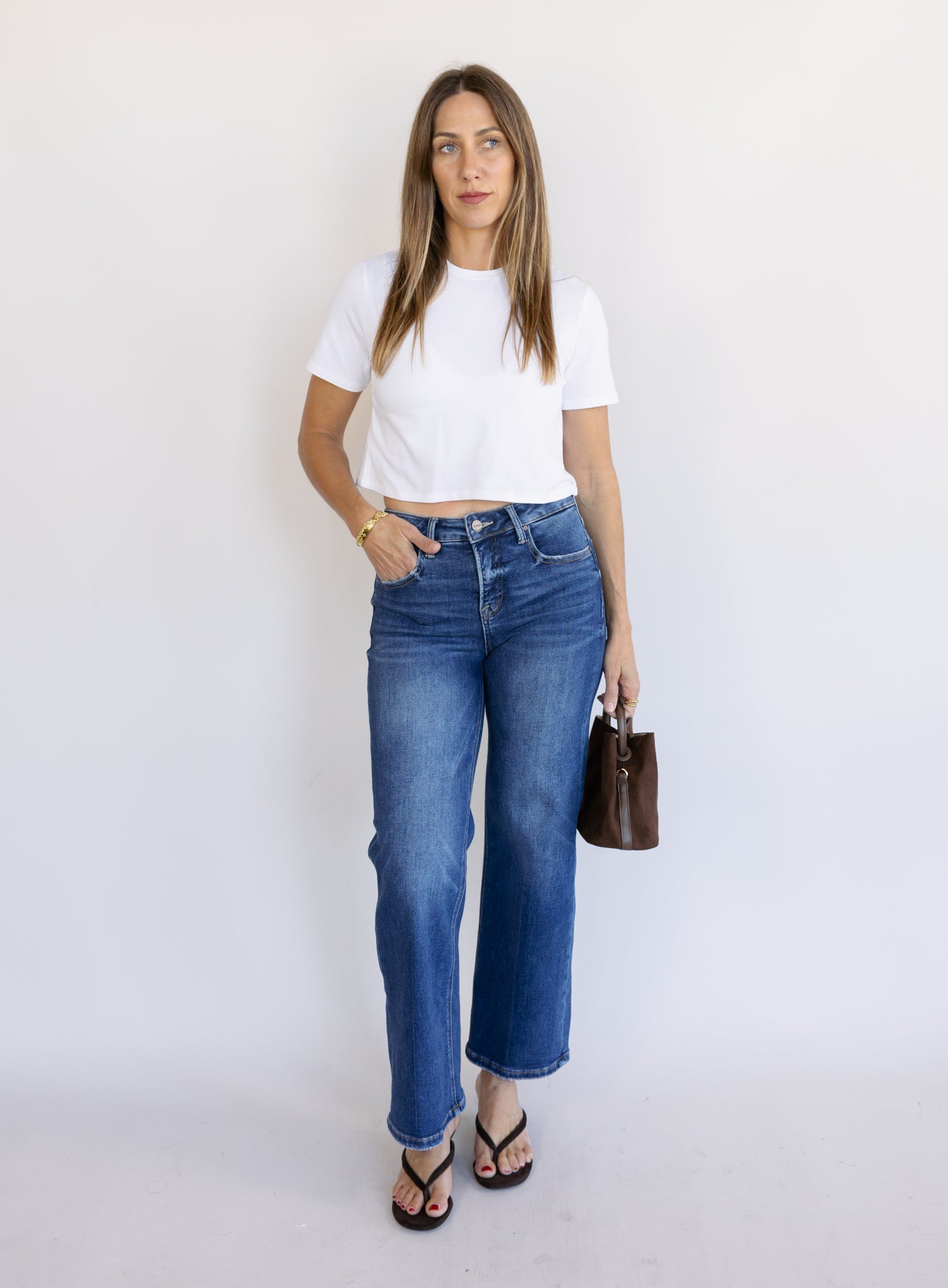 Woman wearing the Jude High Rise Straight Denim, medium blue wash high-rise ankle straight-leg jeans