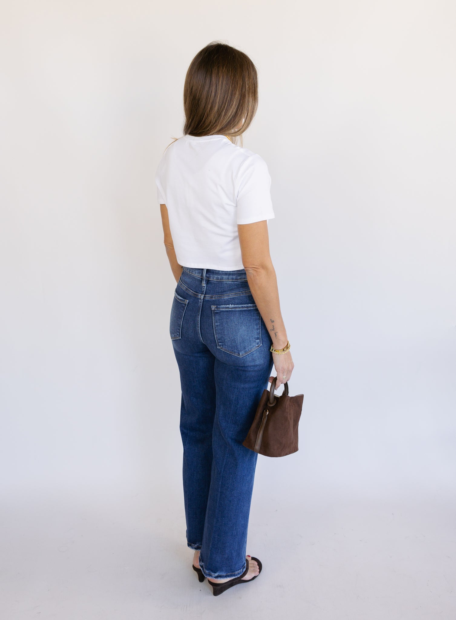 Woman wearing the Jude High Rise Straight Denim, medium blue wash high-rise ankle straight-leg jeans