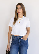 Woman wearing Favorite Daughter The Laura Crop Top in White, a fitted cropped crewneck tee