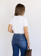 Woman wearing Favorite Daughter The Laura Crop Top in White, a fitted cropped crewneck tee