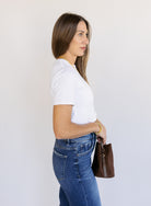 Woman wearing Favorite Daughter The Laura Crop Top in White, a fitted cropped crewneck tee