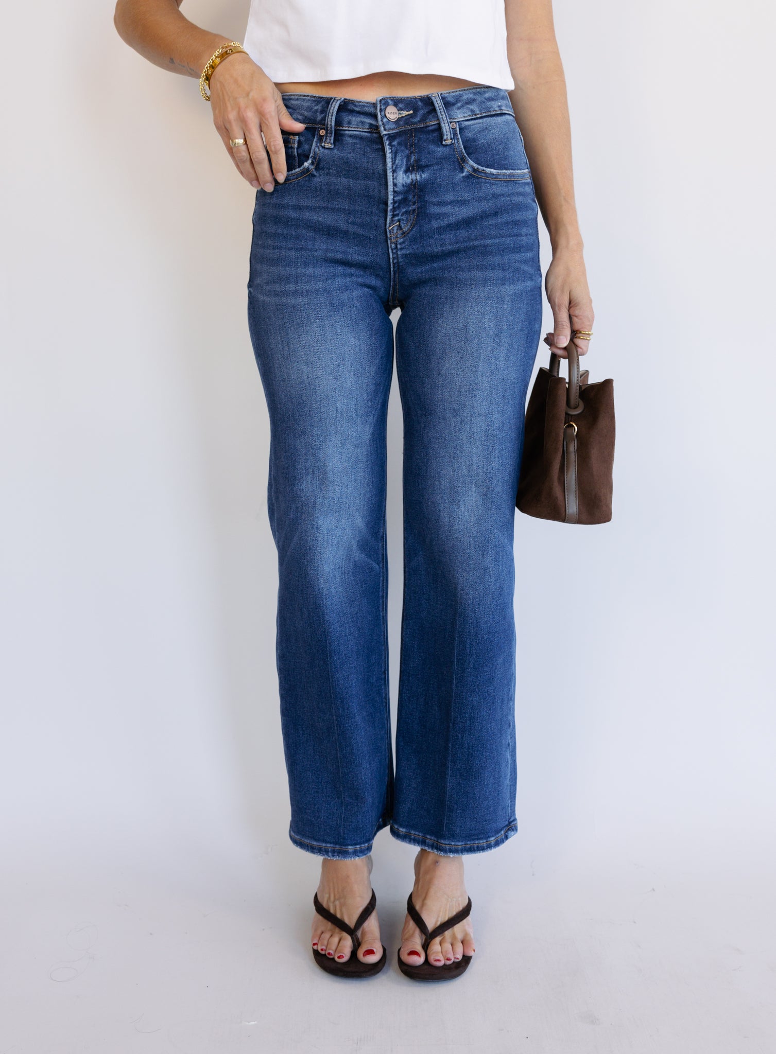 Woman wearing the Jude High Rise Straight Denim, medium blue wash high-rise ankle straight-leg jeans