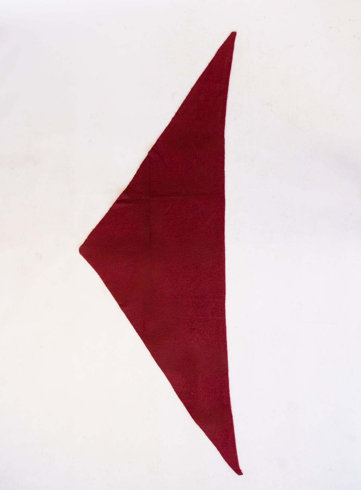 Woman wearing the Wrenley Warm Shawl Scarf in Red, a wine red knit triangle shawl