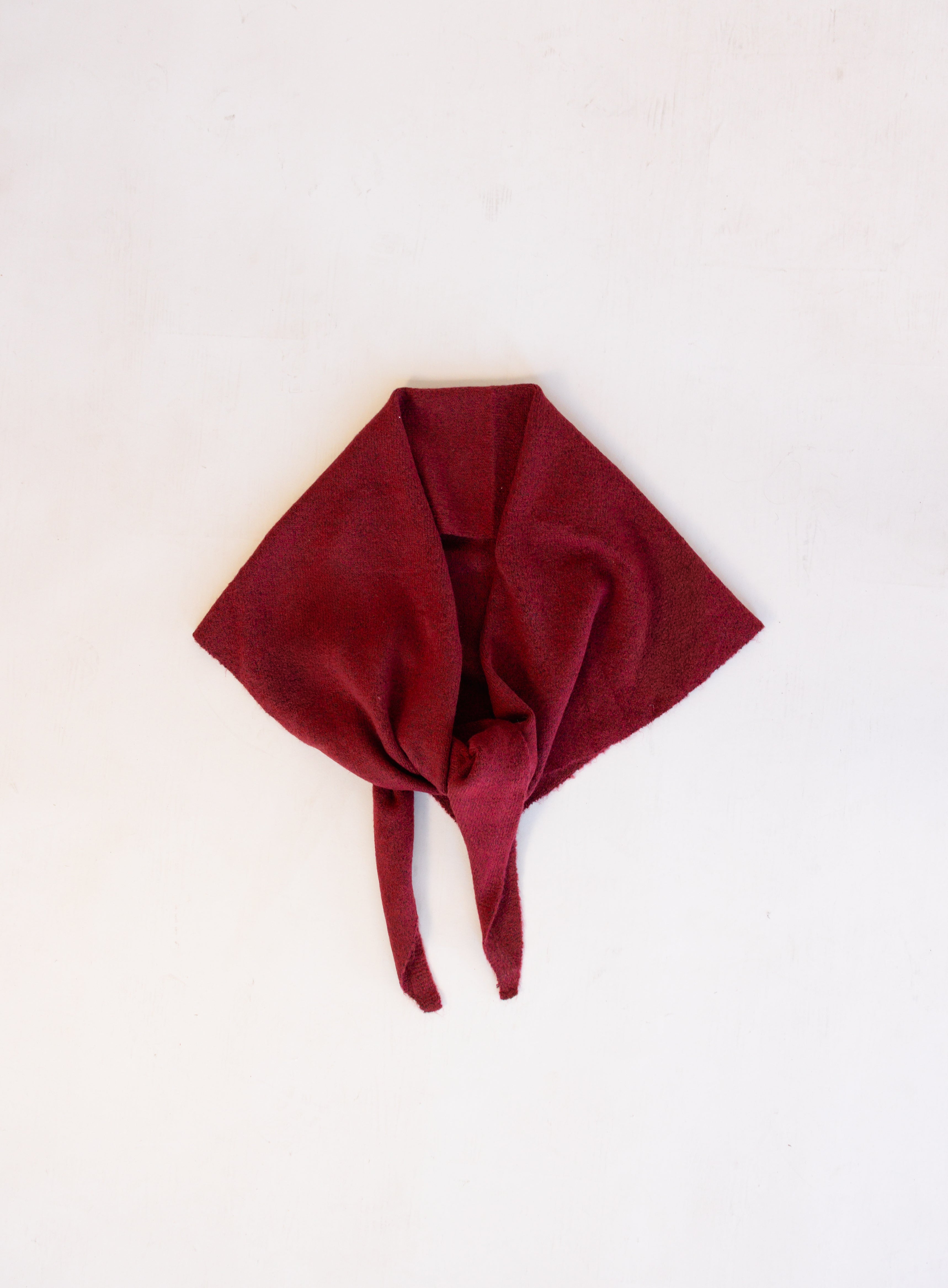 Woman wearing the Wrenley Warm Shawl Scarf in Red, a wine red knit triangle shawl