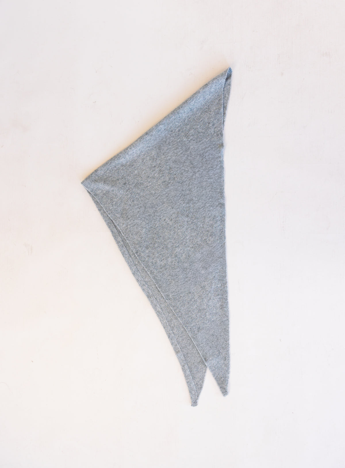Woman wearing the Wrenley Warm Shawl Scarf in Grey, a heathered grey knit triangle shawl