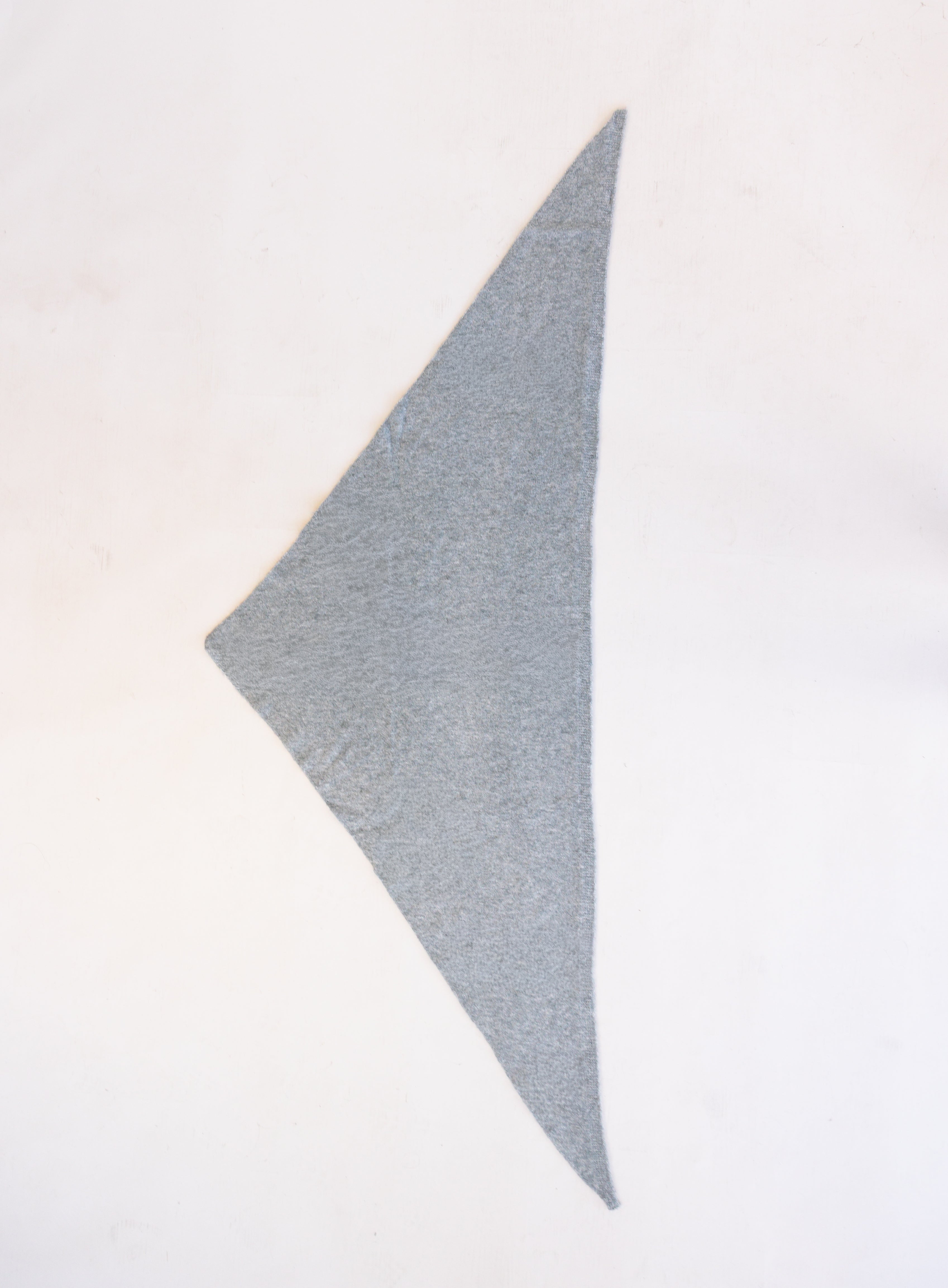 Woman wearing the Wrenley Warm Shawl Scarf in Grey, a heathered grey knit triangle shawl