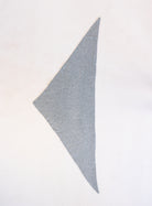 Woman wearing the Wrenley Warm Shawl Scarf in Grey, a heathered grey knit triangle shawl