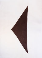 Woman wearing the Wrenley Warm Shawl Scarf in Brown, a chocolate brown knit triangle shawl