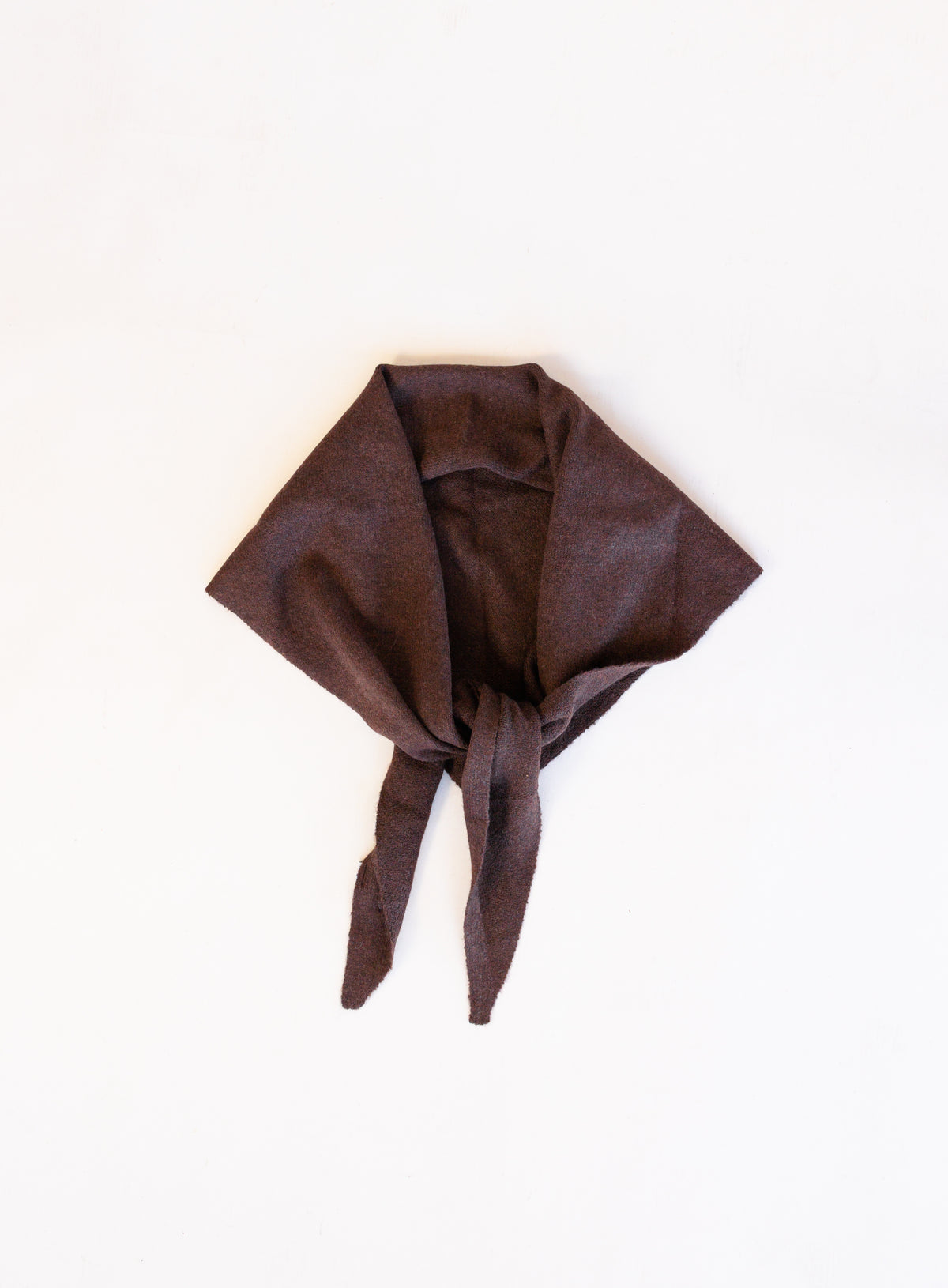 Woman wearing the Wrenley Warm Shawl Scarf in Brown, a chocolate brown knit triangle shawl